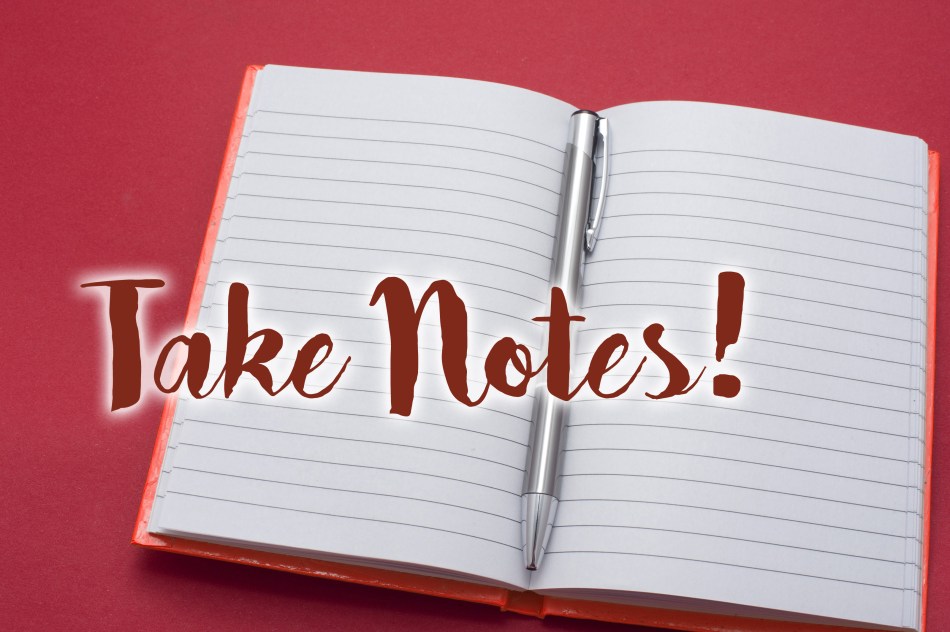 Lined blank notebook opened to the centre with a silver metallic ballpoint pen